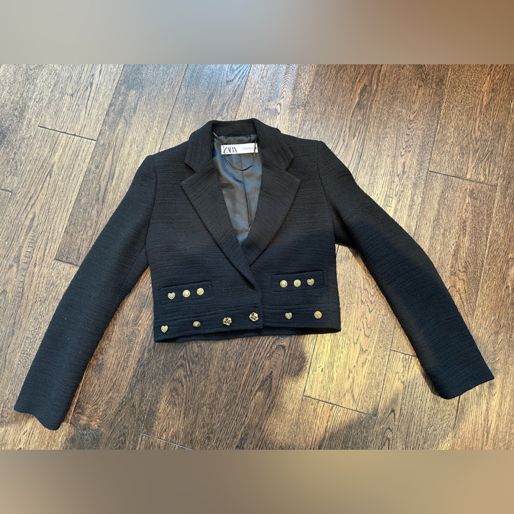Black tweed cropped blazer with gold detailing. Chanel style.